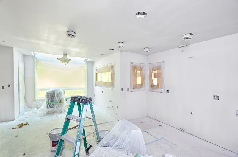 Kitchen wrapped and taped for spray painting the walls and ceiling