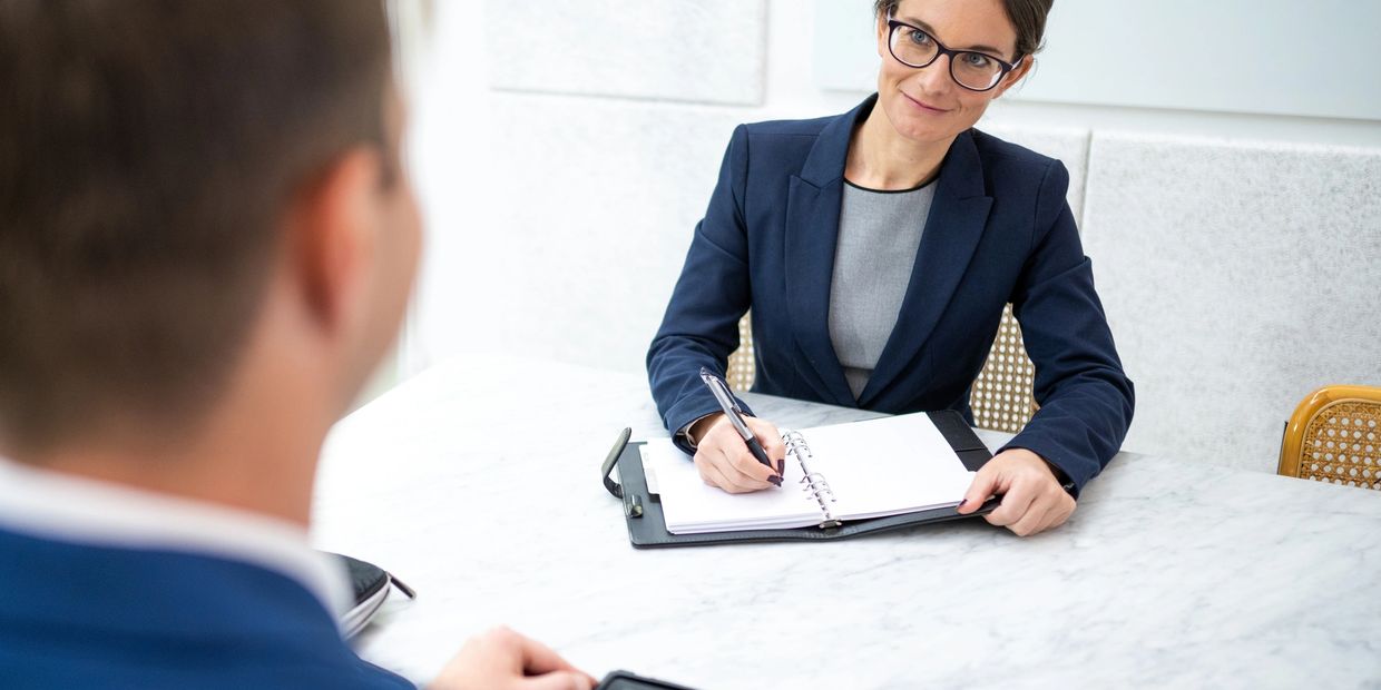 Businesswoman taking notes during a meeting.