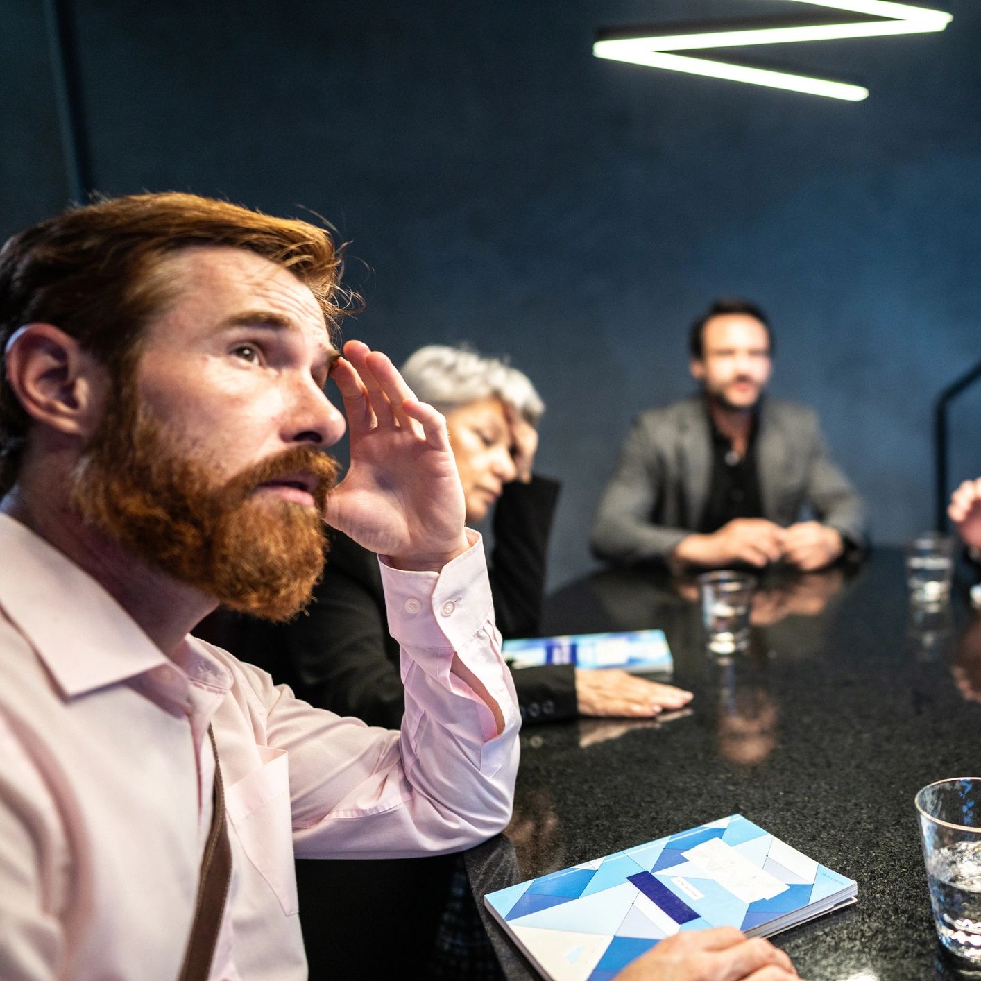 Business meeting with stressed participants.
