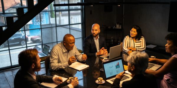 Business meeting with diverse team in modern office.