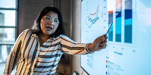 Woman presenting data on a screen.