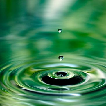 Water dropping into greenish lake