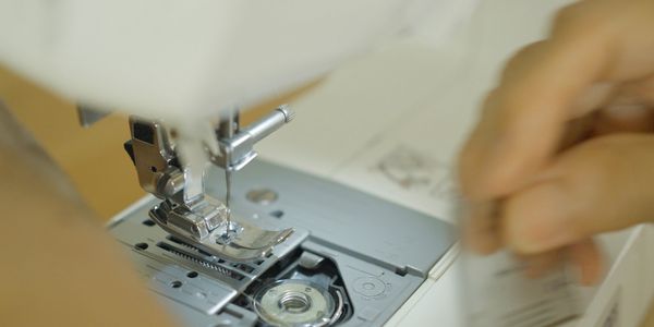Close-up of sewing machine needle and bobbin area.