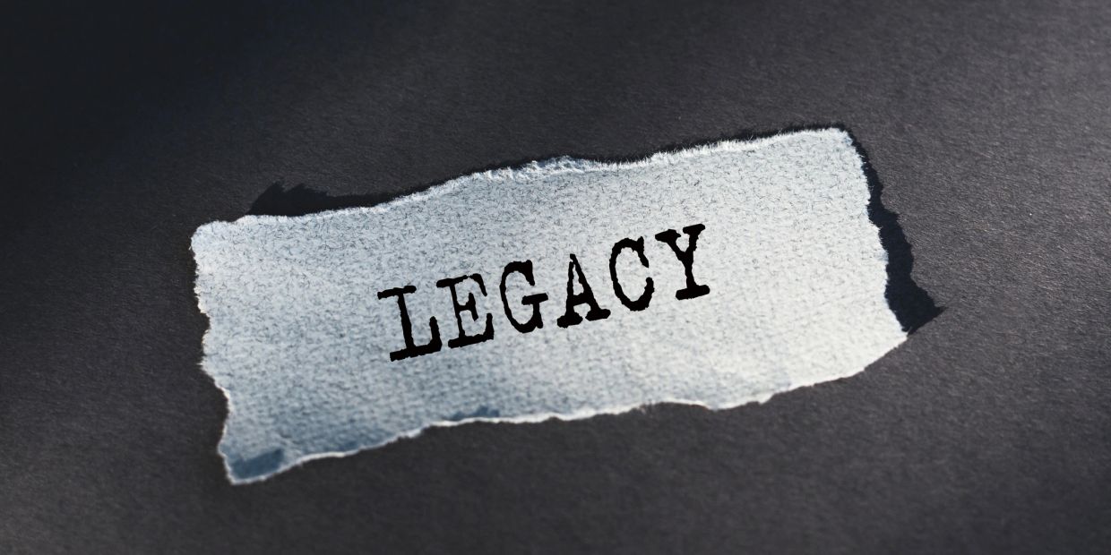 A torn paper with the word 'LEGACY' printed on it.