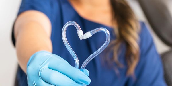 Dentist showing a heart made of tube.