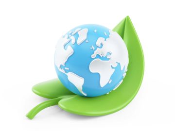 A blue and white Earth globe resting on a green leaf.