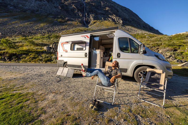 People travel, alternative homes concept. He looks at the beauty in nature. Sunset time on top of mountain pass