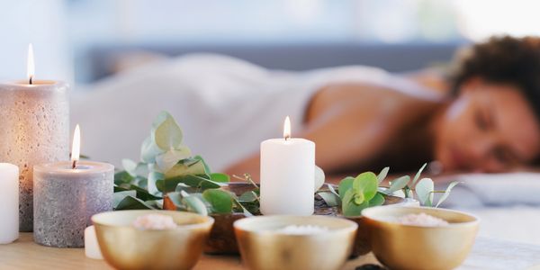 A client relaxing with candles in the foreground.