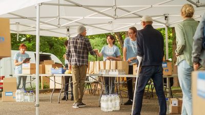 Group of people helping others by Distributing necessities
