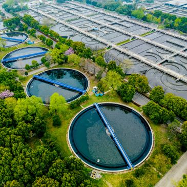 Aerial view of a water treatment plant surrounded by greenery.