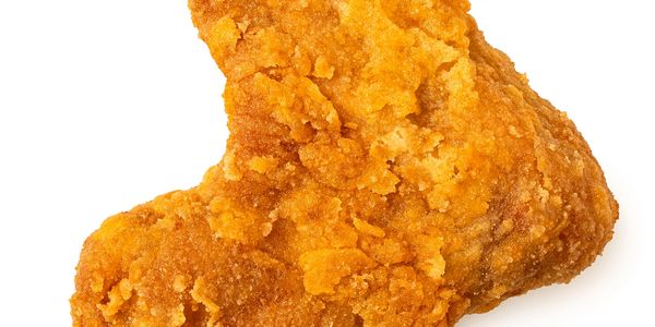 Close-up of a crispy fried chicken wing.