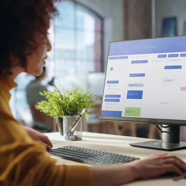 Person working on a computer calendar.