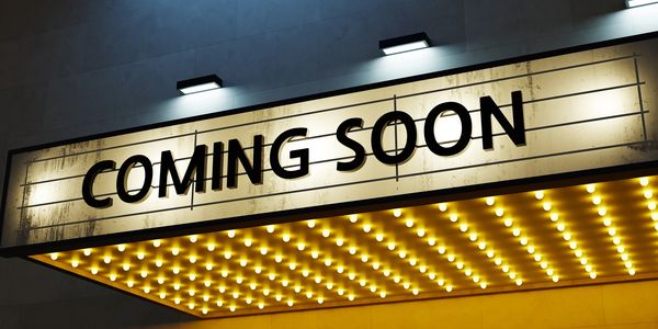 A theater marquee with 'COMING SOON' in bold letters.