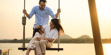 Family on swing smiling