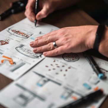 Person sketching and designing on paper.