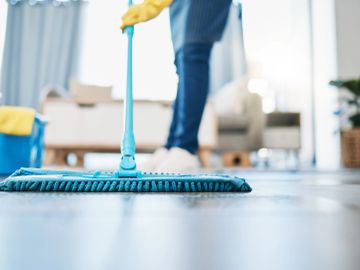 Person mopping floor indoors.