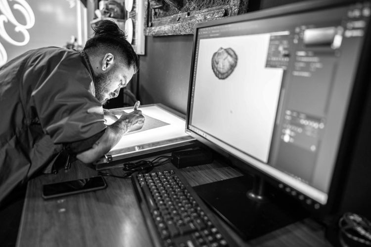 Person designing images on an electronic board