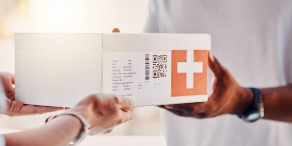Close-up of a parcel exchange with a white box marked with a cross.