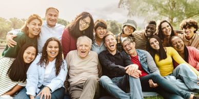 Diverse group of happy people posing outdoors.