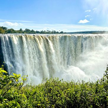 Majestic waterfall cascading with lush greenery.