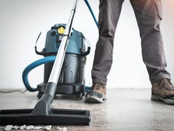 Vacuum post-construction debris during a post-construction cleanup using a shop vac