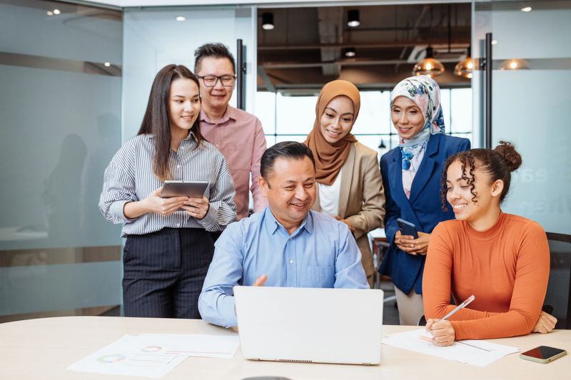 Diverse group of business people in modern office and coworking space working together