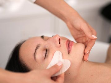Woman receiving a facial treatment.