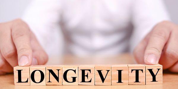 blocks with man spelling out longevity and knows rapamycin can help extend his life 