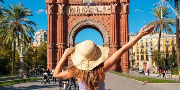 Woman in a sunhat enjoying a sunny day at the Arc de Triomf in Barcelona.