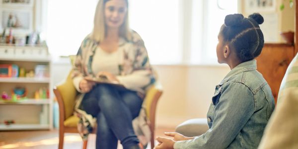 Child speaking with a counselor in a cozy room