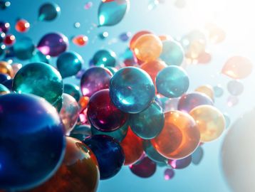 Colorful translucent spheres floating against a bright sky.