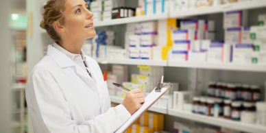 Pharmacist checking inventory in a pharmacy.