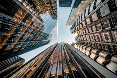 Looking up at tall modern skyscrapers against the sky.