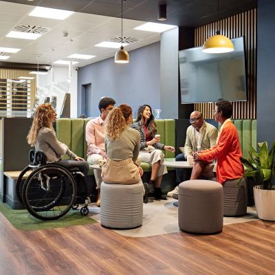 Diverse group having a meeting in a modern office lounge.
