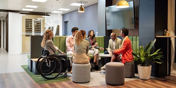 Diverse group having a meeting in a modern office lounge.