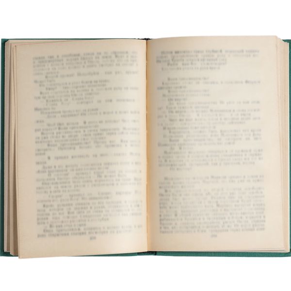 An open vintage book with slightly yellowed pages and blurred text.