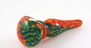 Colorful glass pipes with unique patterns displayed on a white surface.
