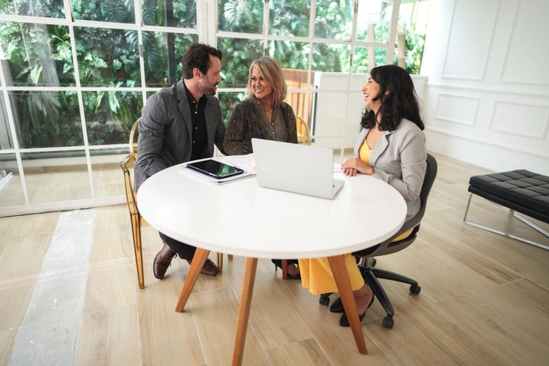 Real estate agent talking to a couple in a house
