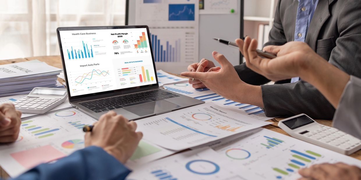 Team meeting with charts and graphs for financial planning and business analytics.
