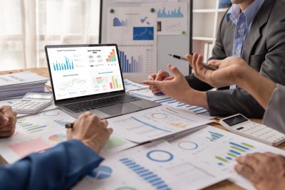 Team discussing data charts and graphs in a meeting.