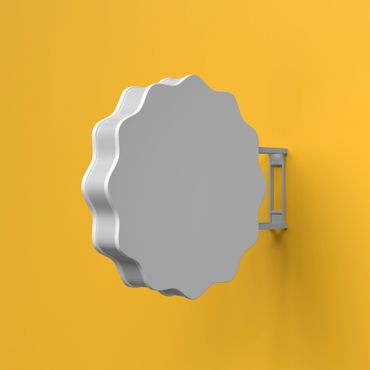 Gray scalloped sign mounted on a yellow wall.