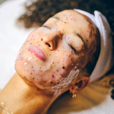 Woman with a floral face mask relaxing.