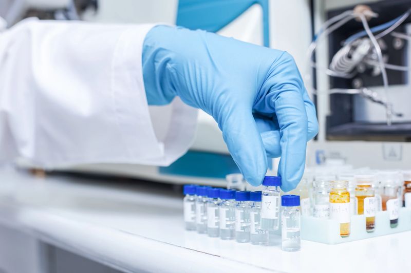 A hand of scientists arrange vials of samples in order of sample or prepare samples for analysis by Liquid Chromatography mass spectrometry LC-MS analysis in lab. LC-MS is used for scientific research.