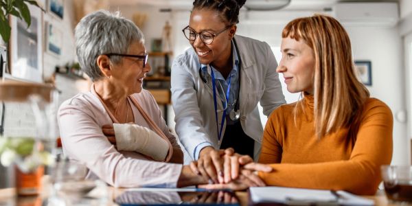 Doctor comforting injured woman during consultation.