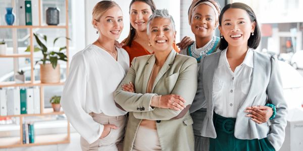 Group of confident professional women smiling.