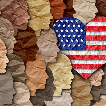 Diverse paper-cut silhouettes with an American flag heart symbolizing unity.
