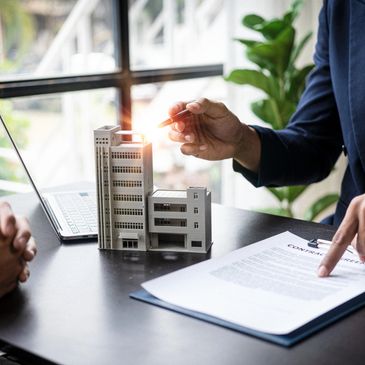 Commercial real estate agent showing paperwork for commercial deal