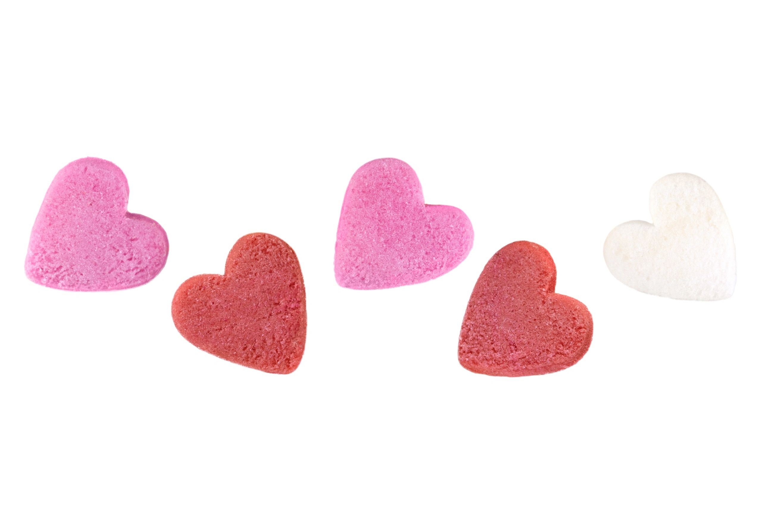 Five hearts in a row, colored shades of pink, white and red.