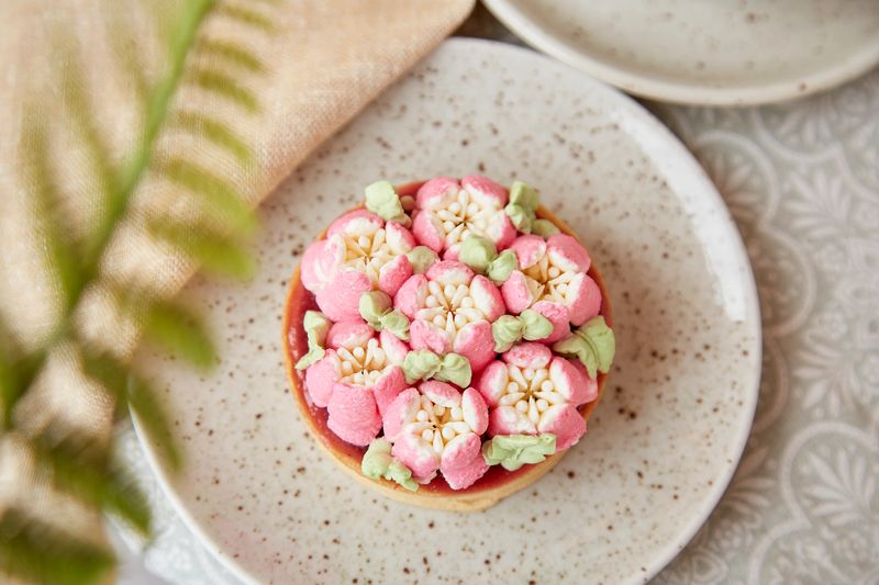 Trendy french tart with flowers. Pink, surreal, escapism flowers cake. Three- dimensional layers background.