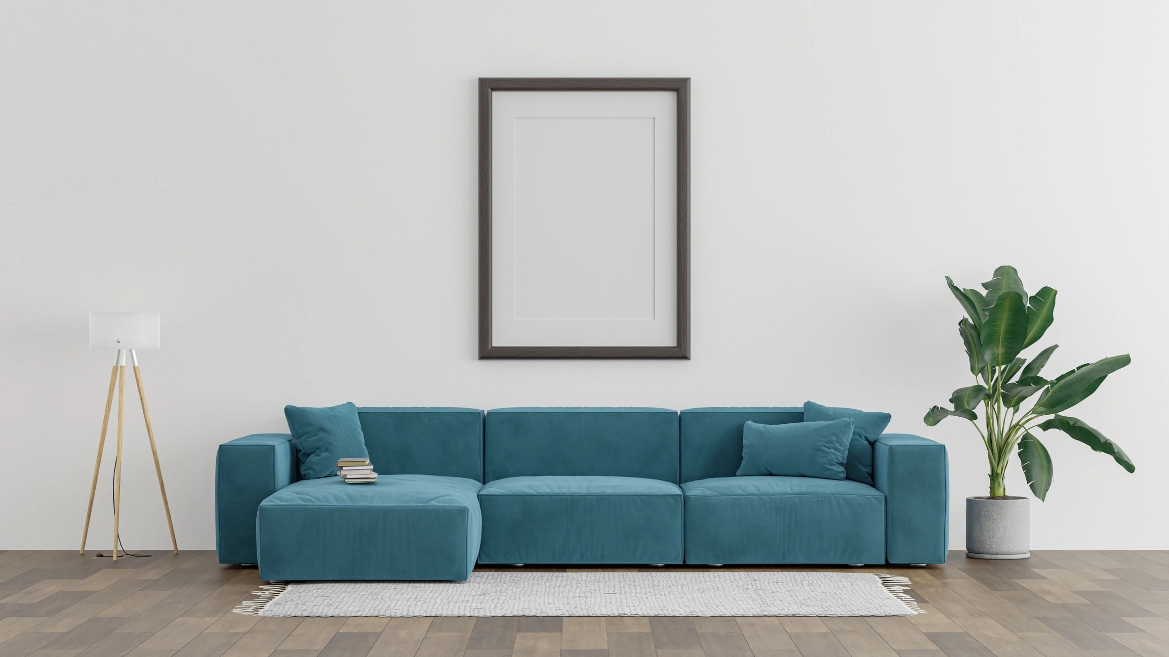 Modern living room with blue sofa, floor lamp, and green plant.